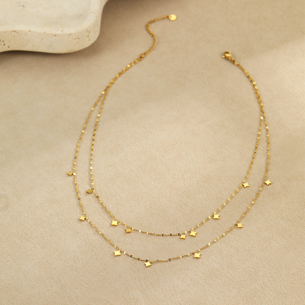 A layered necklace with a dual-layer design element.