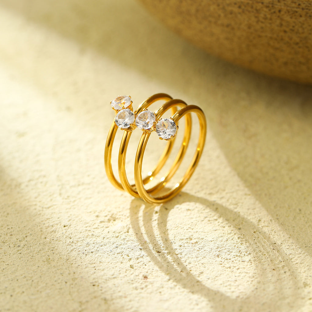 A three-layer ring featuring four zircon stones and an open design
