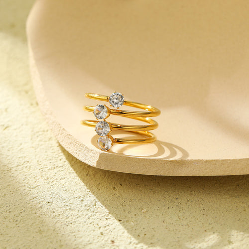 A three-layer ring featuring four zircon stones and an open design