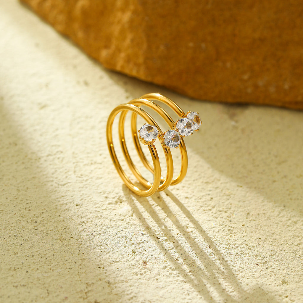 A three-layer ring featuring four zircon stones and an open design